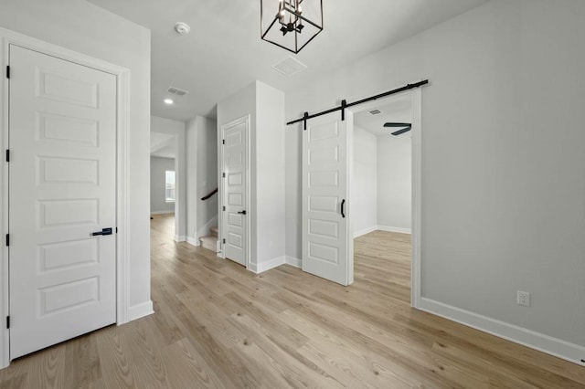 17109 Howdy Way, Manor, TX 78653 - interior space featuring a barn door, a chandelier, baseboards, light wood-style floors, and recessed lighting