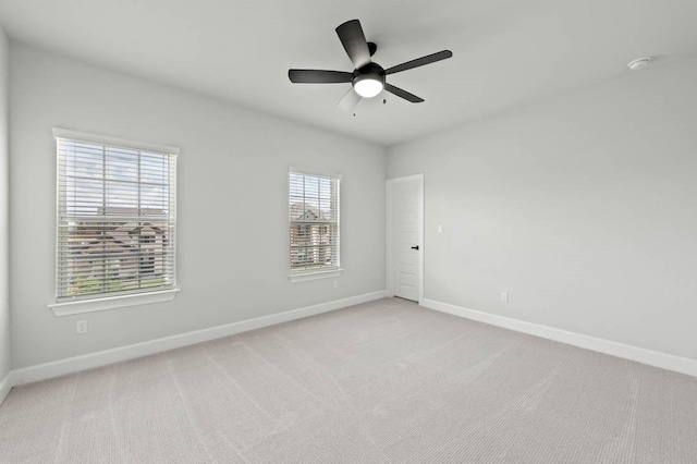 17109 Howdy Way, Manor, TX 78653 - unfurnished room featuring baseboards, light carpet, ceiling fan, and a smoke detector