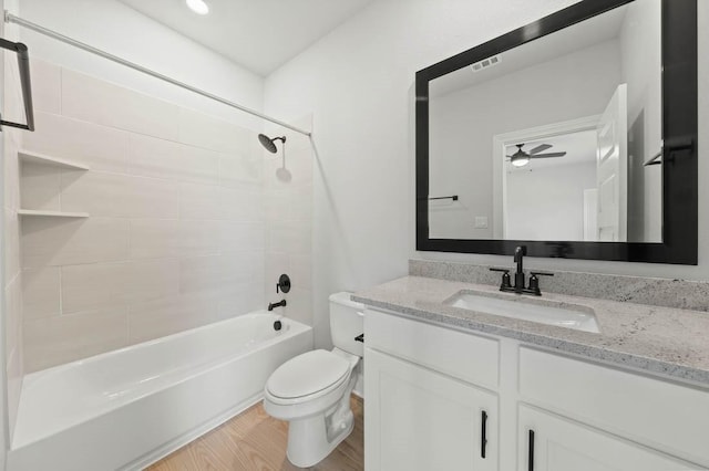 17109 Howdy Way, Manor, TX 78653 - bathroom with toilet, shower / bathtub combination, vanity, wood finished floors, and ceiling fan
