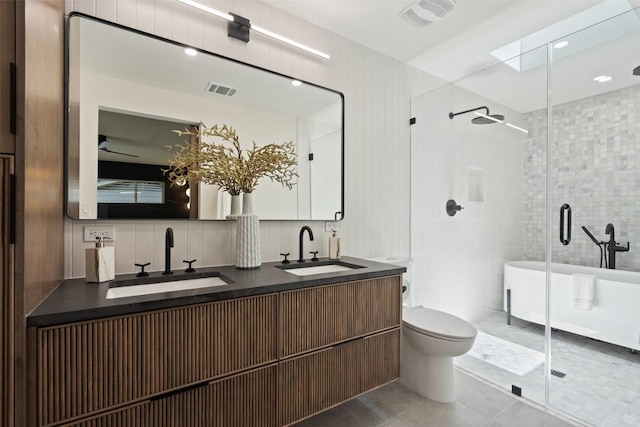 3403 Cascadera Dr, Austin, TX 78731 - full bathroom with tile walls, a shower stall, double vanity, a freestanding tub, and tile patterned flooring