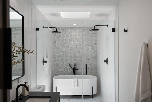 3403 Cascadera Dr, Austin, TX 78731 - bathroom featuring a freestanding tub, tile walls, a tile shower, a skylight, and vanity