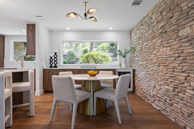 3403 Cascadera Dr, Austin, TX 78731 - dining area featuring a chandelier, wood finished floors, wine cooler, and recessed lighting