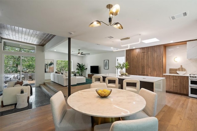 3403 Cascadera Dr, Austin, TX 78731 - dining room featuring light wood-style floors, beamed ceiling, ceiling fan, recessed lighting, and a chandelier