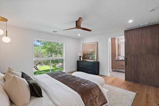 3403 Cascadera Dr, Austin, TX 78731 - bedroom featuring light wood finished floors, a ceiling fan, recessed lighting, and ensuite bathroom