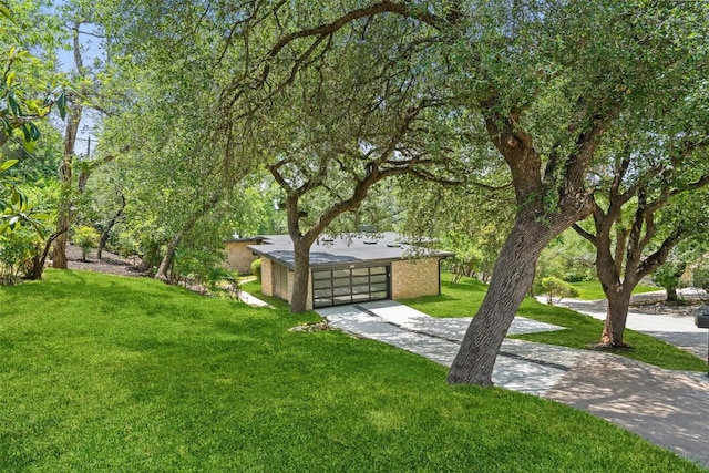 3403 Cascadera Dr, Austin, TX 78731 - view of green lawn with concrete driveway and a garage