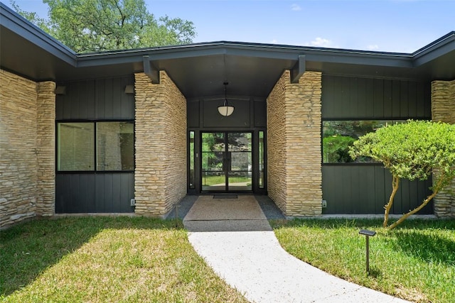 3403 Cascadera Dr, Austin, TX 78731 - view of exterior entry featuring stone siding and a lawn