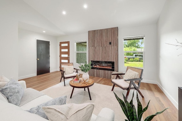 3812 Tarragona Ln, Austin, TX 78727 - living area with lofted ceiling, recessed lighting, a large fireplace, light wood-type flooring, and baseboards