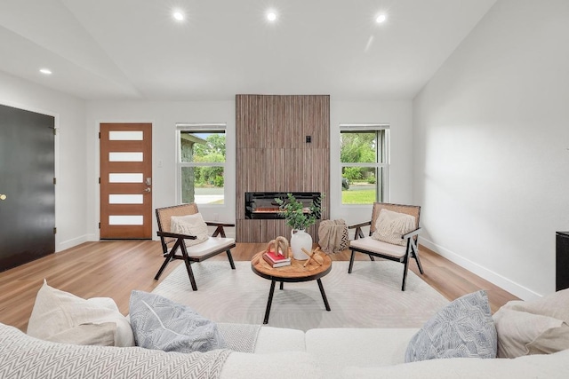 3812 Tarragona Ln, Austin, TX 78727 - living area with lofted ceiling, recessed lighting, light wood finished floors, baseboards, and a fireplace
