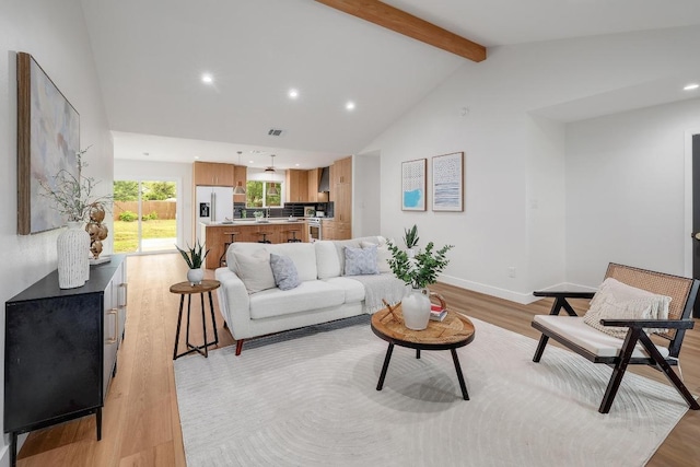 3812 Tarragona Ln, Austin, TX 78727 - living area featuring light wood-type flooring, beam ceiling, recessed lighting, baseboards, and high vaulted ceiling