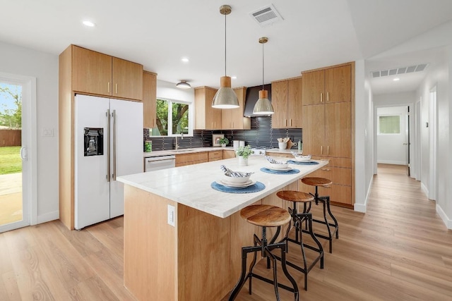 3812 Tarragona Ln, Austin, TX 78727 - kitchen with high quality fridge, dishwasher, a kitchen breakfast bar, a sink, and light wood finished floors