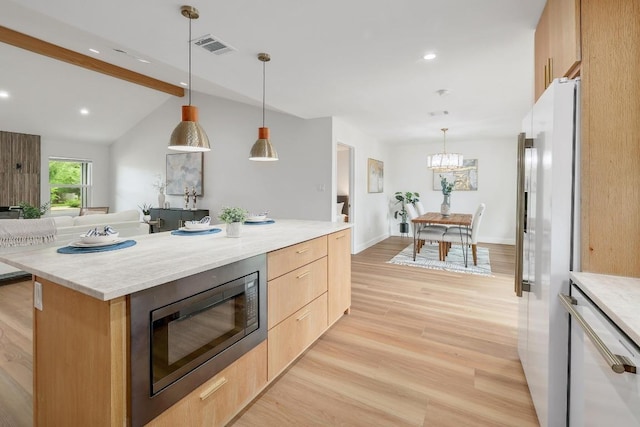 3812 Tarragona Ln, Austin, TX 78727 - kitchen with white appliances, light brown cabinetry, light wood finished floors, a chandelier, and open floor plan