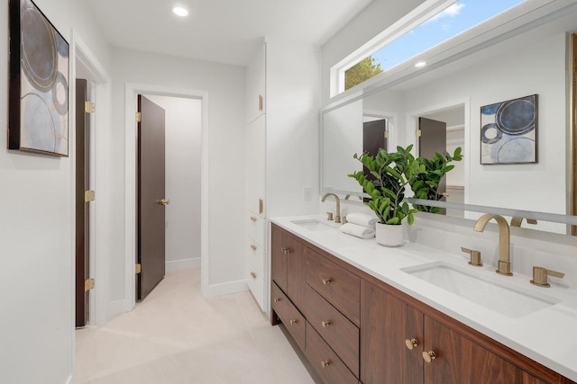 3812 Tarragona Ln, Austin, TX 78727 - full bathroom with double vanity, recessed lighting, and baseboards