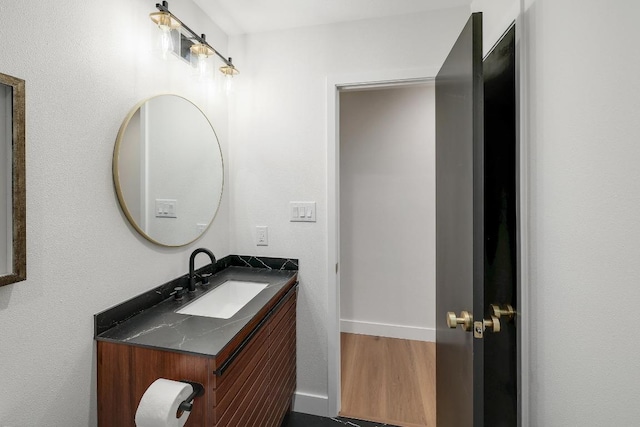 3812 Tarragona Ln, Austin, TX 78727 - bathroom featuring vanity, baseboards, and wood finished floors