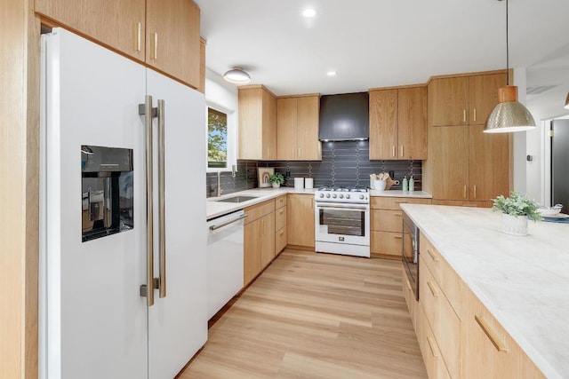 3812 Tarragona Ln, Austin, TX 78727 - kitchen featuring white appliances, a sink, light wood-style flooring, tasteful backsplash, and wall chimney exhaust hood