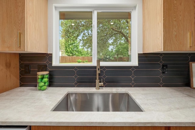 3812 Tarragona Ln, Austin, TX 78727 - kitchen with a sink, backsplash, light stone counters, and healthy amount of natural light