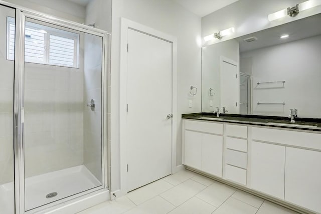 301 W Stassney Ln Unit 7, Austin, TX 78745 - bathroom with a stall shower, tile patterned flooring, and double vanity