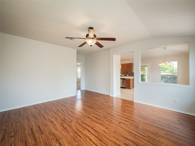 604 Creston St, Hutto, TX 78634 - unfurnished living room with light wood-type flooring, healthy amount of natural light, and a chandelier