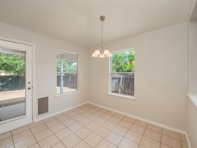 604 Creston St, Hutto, TX 78634 - spare room featuring healthy amount of natural light, a chandelier, baseboards, and light tile patterned flooring