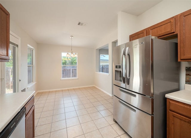 604 Creston St, Hutto, TX 78634 - kitchen with appliances with stainless steel finishes, a chandelier, brown cabinets, baseboards, and hanging light fixtures
