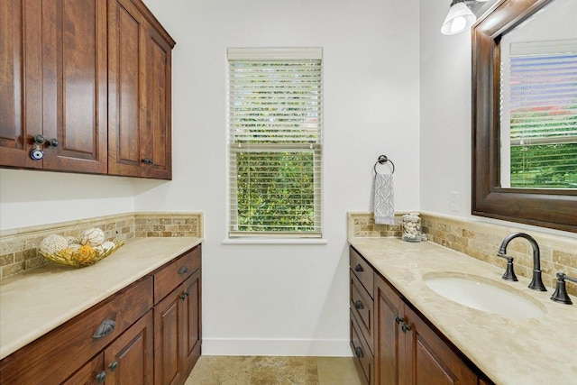 9308 Prince Charles, Austin, TX 78730 - bathroom with decorative backsplash, vanity, baseboards, and plenty of natural light