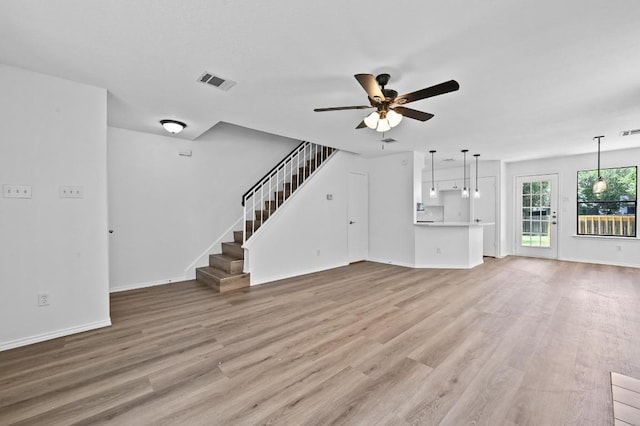 909 Silcantu Dr, Austin, TX 78748 - unfurnished living room featuring a ceiling fan, light wood-style flooring, baseboards, and stairs