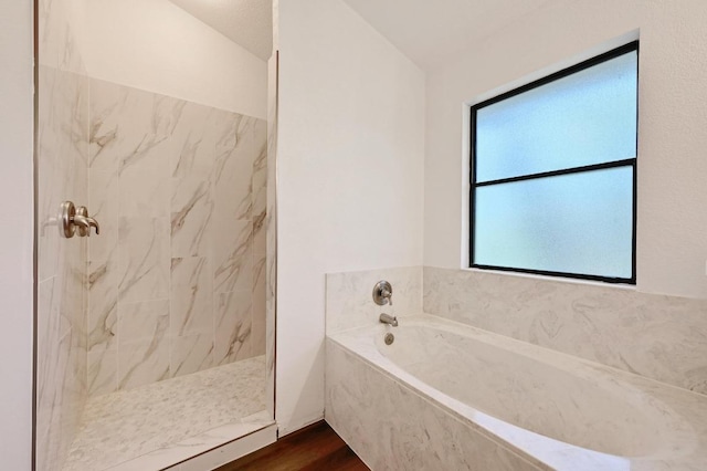909 Silcantu Dr, Austin, TX 78748 - bathroom featuring a garden tub, a marble finish shower, and wood finished floors