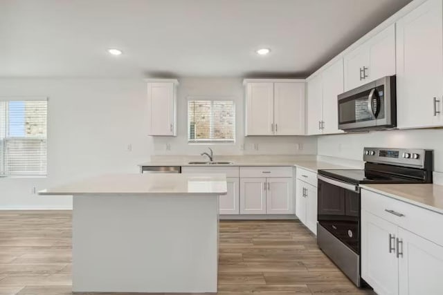 2807 Dimmit Dr, Temple, TX 76501 - kitchen with appliances with stainless steel finishes, light countertops, plenty of natural light, white cabinetry, and recessed lighting