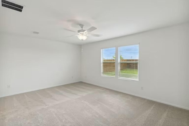 2807 Dimmit Dr, Temple, TX 76501 - spare room featuring light colored carpet, a ceiling fan, and baseboards