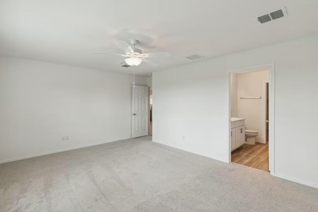 2807 Dimmit Dr, Temple, TX 76501 - unfurnished bedroom featuring light colored carpet, ensuite bathroom, baseboards, and ceiling fan