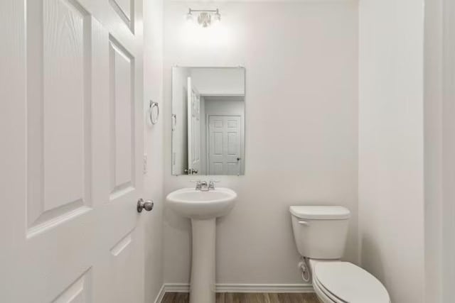 2807 Dimmit Dr, Temple, TX 76501 - half bath with toilet, a sink, wood finished floors, and baseboards