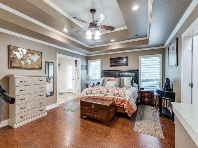 20104 Bunker Cv, Lago Vista, TX 78645 - bedroom with a raised ceiling, multiple windows, crown molding, wood-type flooring, and ceiling fan