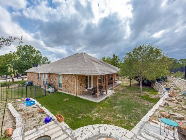 20104 Bunker Cv, Lago Vista, TX 78645 - rear view of house with a patio, a fenced backyard, roof with shingles, and stone siding