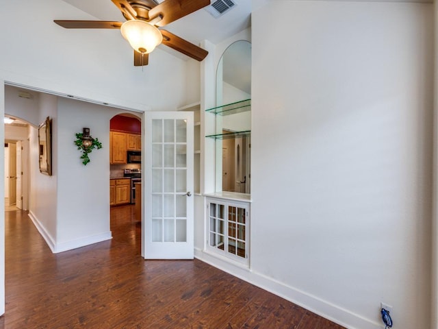 20104 Bunker Cv, Lago Vista, TX 78645 - unfurnished room with arched walkways, dark wood-style floors, a ceiling fan, and high vaulted ceiling