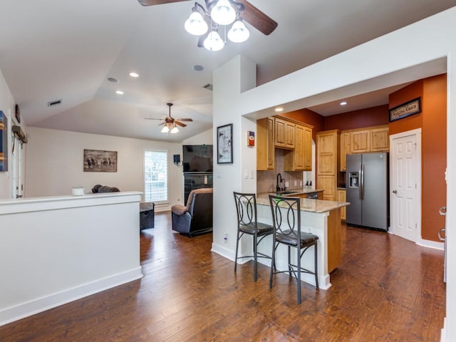20104 Bunker Cv, Lago Vista, TX 78645 - kitchen featuring stainless steel fridge, ceiling fan, a peninsula, vaulted ceiling, and dark wood-style flooring