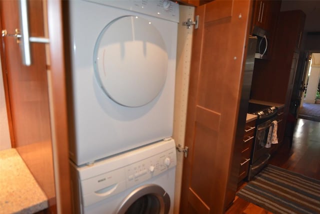3404 American Dr Unit 2101, Lago Vista, TX 78645 - laundry room featuring stacked washing machine and dryer and dark wood-type flooring