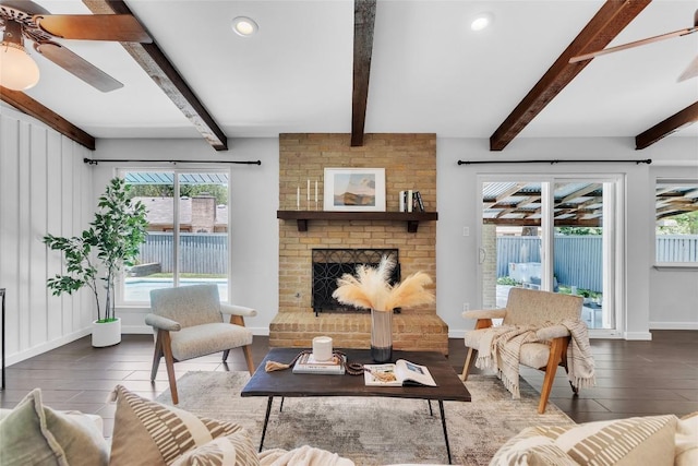 10108 Osprey Ct, Austin, TX 78750 - living area with wood finished floors, ceiling fan, beamed ceiling, a fireplace, and recessed lighting
