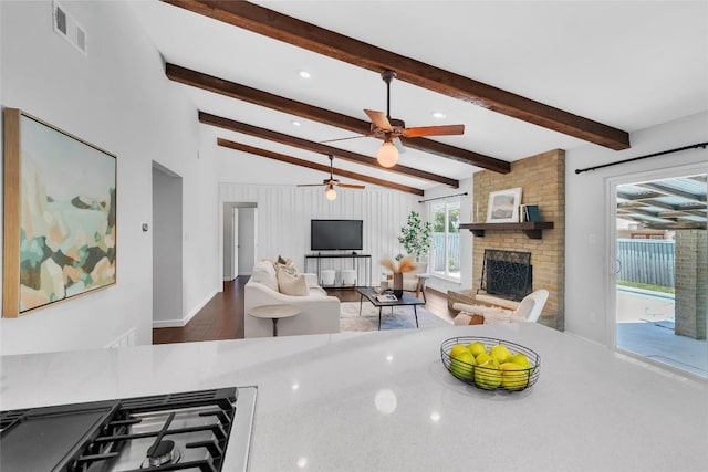 10108 Osprey Ct, Austin, TX 78750 - living room with a brick fireplace, a ceiling fan, wood finished floors, and recessed lighting