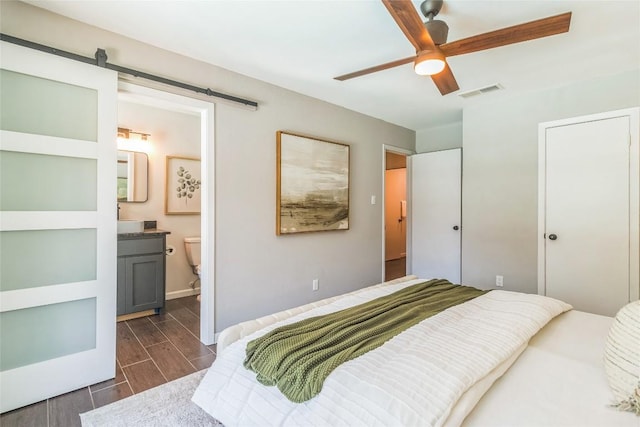 10108 Osprey Ct, Austin, TX 78750 - bedroom with wood tiled floors, ensuite bath, and a ceiling fan