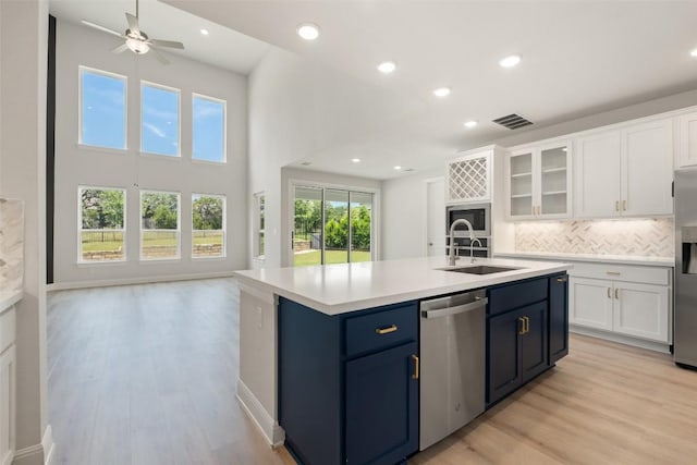 159 Fireside Rd, Austin, TX 78737 - kitchen featuring appliances with stainless steel finishes, white cabinetry, light countertops, light wood-style flooring, and recessed lighting