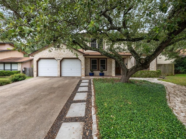 12208 Antoinette Pl, Austin, TX 78727 - view of front of property with a garage, concrete driveway, and stone siding