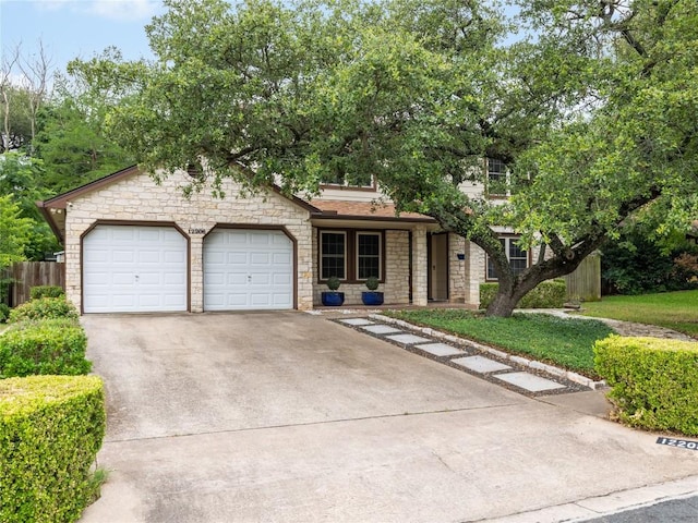 12208 Antoinette Pl, Austin, TX 78727 - view of front facade with stone siding, concrete driveway, and an attached garage