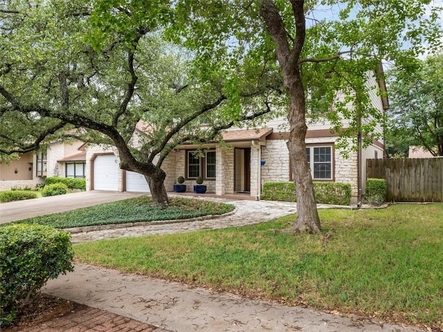 12208 Antoinette Pl, Austin, TX 78727 - view of front facade featuring stone siding, concrete driveway, and a garage