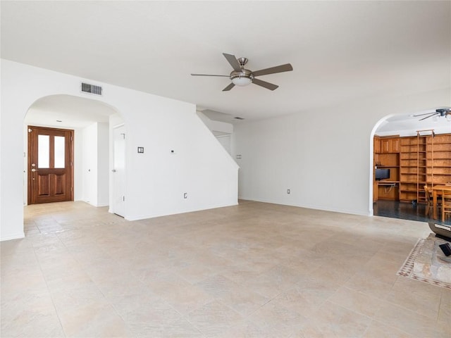 12208 Antoinette Pl, Austin, TX 78727 - unfurnished living room with a ceiling fan, arched walkways, baseboards, and light tile patterned floors