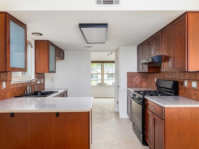 12208 Antoinette Pl, Austin, TX 78727 - kitchen with black range with gas stovetop, a sink, under cabinet range hood, backsplash, and light countertops