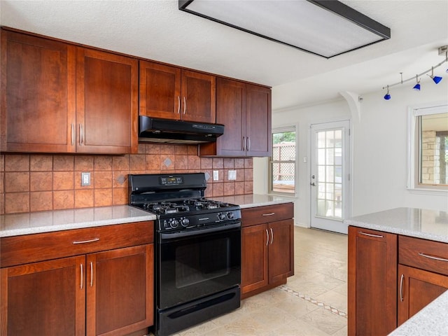 12208 Antoinette Pl, Austin, TX 78727 - kitchen with black gas range oven, under cabinet range hood, light countertops, and decorative backsplash