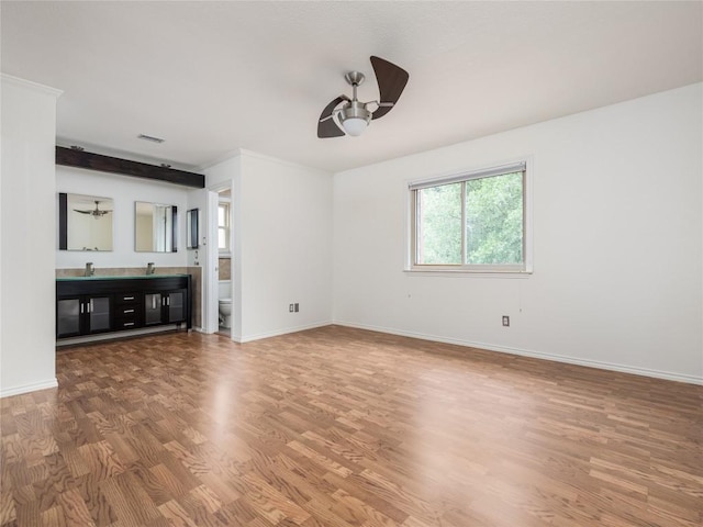 12208 Antoinette Pl, Austin, TX 78727 - unfurnished living room featuring ceiling fan, wood finished floors, baseboards, and a sink