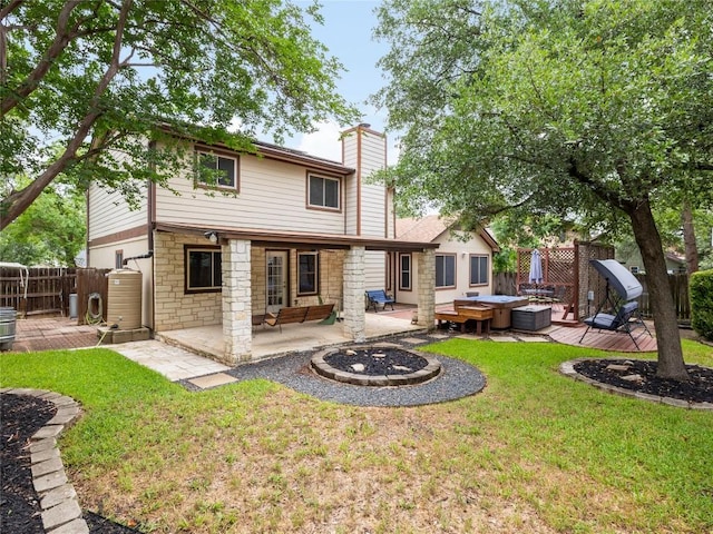 12208 Antoinette Pl, Austin, TX 78727 - back of property featuring a fire pit, stone siding, a chimney, a patio, and a wooden deck