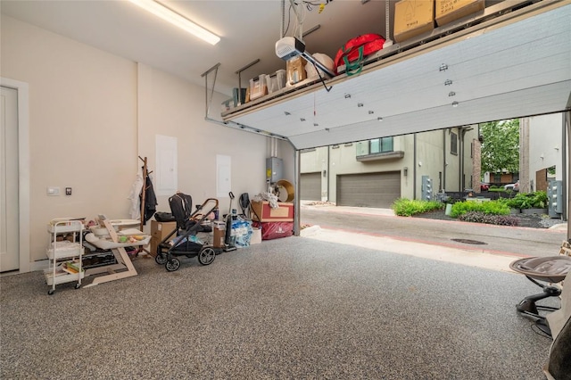 4702 Unity Cir, Austin, TX 78731 - garage featuring a garage door opener and water heater