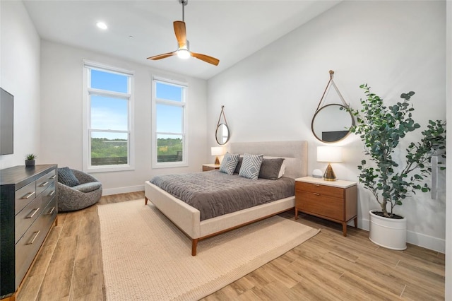 4702 Unity Cir, Austin, TX 78731 - bedroom featuring light wood finished floors, baseboards, a ceiling fan, and vaulted ceiling