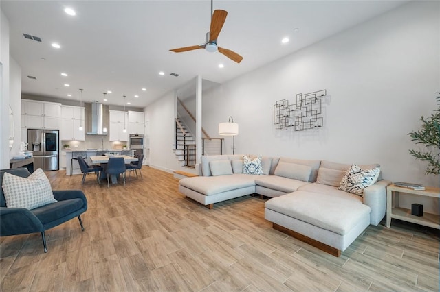 4702 Unity Cir, Austin, TX 78731 - living room with stairs, light wood-style floors, recessed lighting, ceiling fan, and baseboards